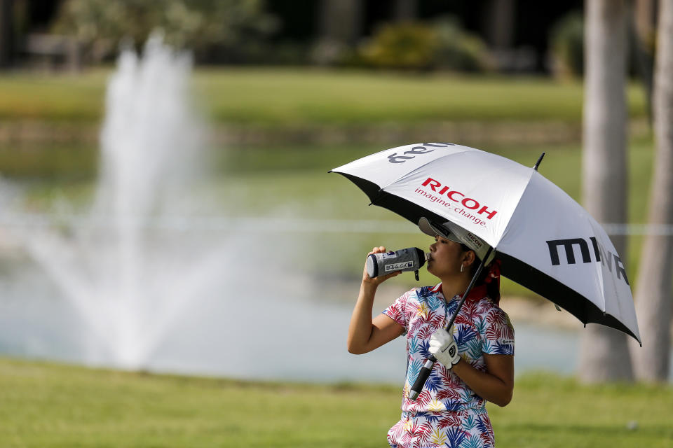 Yui Kawamoto, of Japan, drinks on the fourth hole during the first round of the the ANA Inspiration golf tournament at Mission Hills Country Club in Rancho Mirage, Calif., Thursday, Sept. 10, 2020. (AP Photo/Ringo H.W. Chiu)