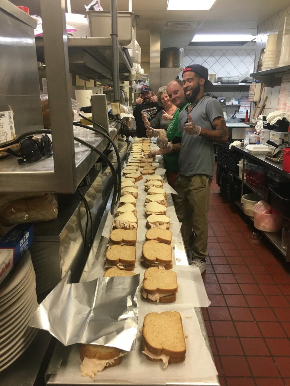 The team at Tanks Bar & Grill in Dayton make sandwiches for tornado victims. CONTRIBUTED