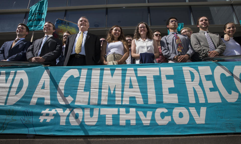 FILE - In this July 18, 2018, file photo, lawyers and youth plaintiffs lineup behind a banner after a hearing before Federal District Court Judge Ann Aiken between lawyers for the Trump Administration and the so called Climate Kids in Federal Court in Eugene, Ore. A federal appeals court on Friday, Jan. 17, 2020, dismissed a lawsuit by 21 young people who claimed the U.S. government's climate policy harms them and jeopardizes their future. (Chris Pietsch/The Register-Guard via AP, File)