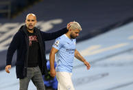 Manchester City's Sergio Aguero passes by Manchester City's head coach Pep Guardiola after being substituted during the English Premier League soccer match between Manchester City and Arsenal at the Etihad stadium in Manchester, England, Saturday, Oct. 17, 2020. (Alex Livesey/Pool via AP)