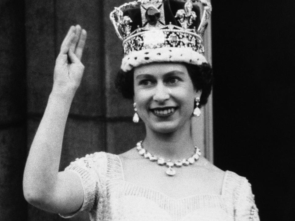 Queen Elizabeth waves from the balcony of Buckingham Palace at her coronation