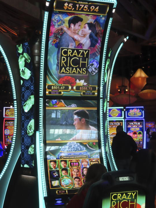 A gambler plays a slot machine at the Ocean Casino Resort in Atlantic City, N.J. on Nov. 29, 2023. Internet gambling and sports betting both set new records in November as gamblers continue to take advantage of more options in addition to traveling to physical casinos in order to wager. (AP Photo/Wayne Parry)