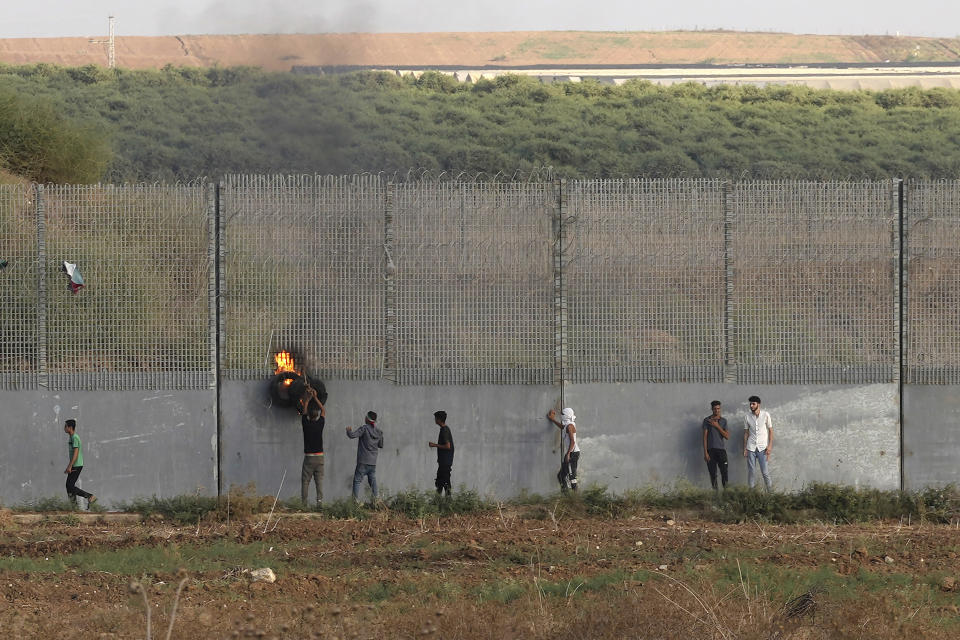 Palestinian protesters clash with Israeli security forces along the frontier with Israel during a demonstration marking Israel's withdrawal from Gaza in 2005, east of Gaza City, Wednesday, Sept. 13, 2023. Activists said at least four people were killed in an explosion. The Israeli army said the blast took place when protesters tried to throw explosives over the fence. (AP Photo/Adel Hana)