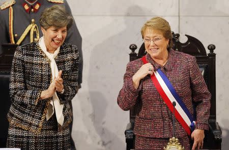 Chile's President Michelle Bachelet smiles next to Senate President Isabel Allende (L), daughter of late former President Salvador Allende, after delivering her annual address at the national congress building in Valparaiso city, northwest of Santiago, in this May 21, 2014 file photo. REUTERS/Eliseo Fernandez/Files