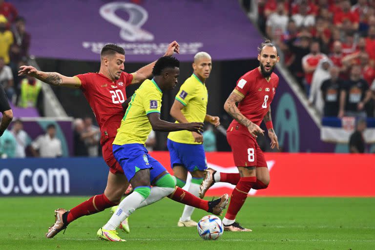 Serbia's midfielder #20 Sergej Milinkovic-Savic (L) fights for the ball with Brazil's forward #20 Vinicius Junior (2nd L) during the Qatar 2022 World Cup Group G football match between Brazil and Serbia at the Lusail Stadium in Lusail, north of Doha on November 24, 2022. (Photo by NELSON ALMEIDA / AFP)