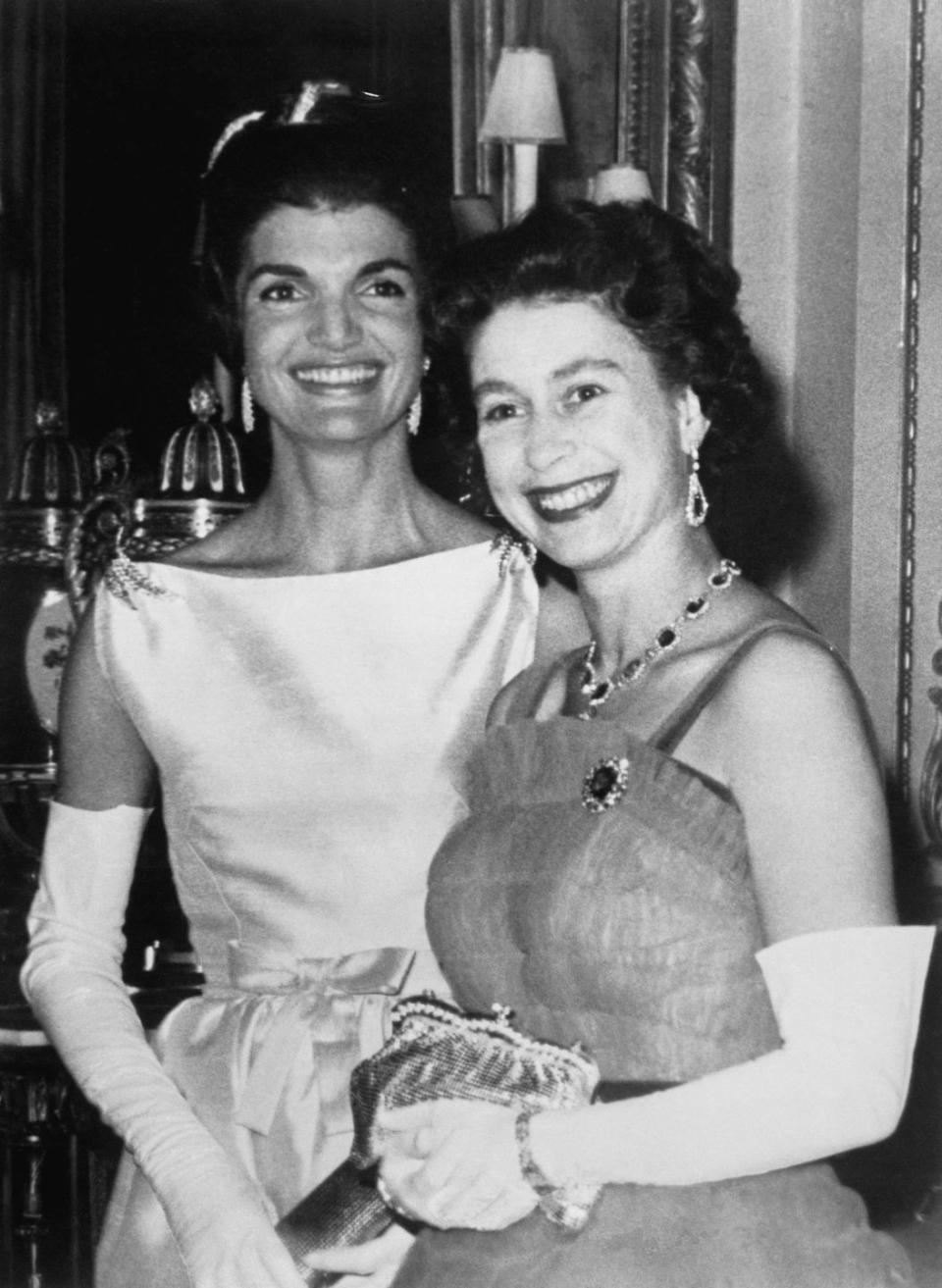 <p>Queen Elizabeth poses with Jackie Kennedy, the First Lady of the United States at the time, during a dinner at Buckingham Palace. It was the first time the president of the United States had been invited to dine at Buckingham Palace since 1918.</p>
