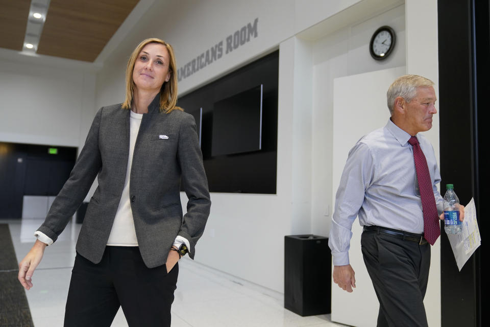 Iowa head coach Kirk Ferentz leaves a news conference past Iowa interim athletic director Beth Goetz, left, Tuesday, Oct. 31, 2023, in Iowa City, Iowa. Goetz announced on Monday that Ferentz's son, Brian, would not return as offensive coordinator next year. (AP Photo/Charlie Neibergall)