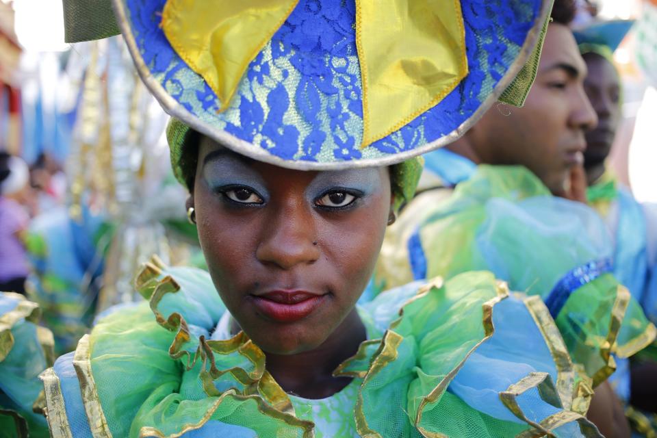 FILE - In this May 17, 2018 file photo, a member of the LGBT community strikes a pose while waiting for the start of a parade marking the International Day Against Homophobia, Transphobia and Biphobia, in Pinar Del Rio, Cuba. (AP Photo/Desmond Boylan, File)