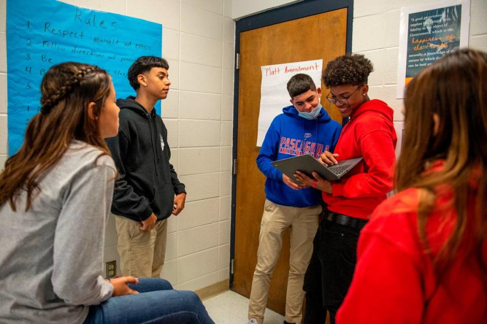 Reinaldo Caraballo, Angel Solivan, center, and Joseph Santana, center right, participate in a group activity during a history class at Pascagoula High School on Monday, Oct. 25, 2021.