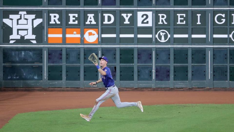 Texas Rangers center fielder Evan Carter makes a catch during the fifth inning of Game 1 of the ALCS against the Houston Astros in the 2023 MLB playoffs at Minute Maid Park.