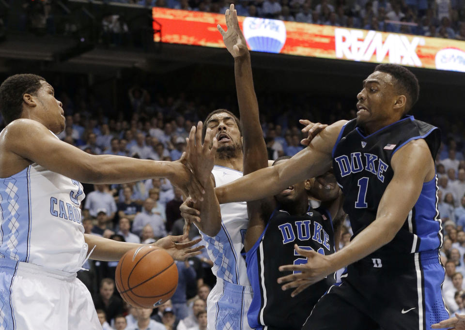 North Carolina's Kennedy Meeks, left, and James Michael McAdoo struggle for possession of the ball with Duke's Amile Jefferson and Jabari Parker (1) during the first half of an NCAA college basketball game in Chapel Hill, N.C., Thursday, Feb. 20, 2014. (AP Photo/Gerry Broome)