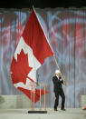 RICHMOND, CANADA - FEBRUARY 12: Simon Whitfield, Olympic gold and silver medalist in the triathlon, waves a Canadian flag during a ceremony for the one year countdown of the 2010 Olympic Games on February 12, 2009 at the Richmond Olympic Oval in Richmond, British Columbia, Canada. (Photo by Jeff Vinnick/Getty Images)