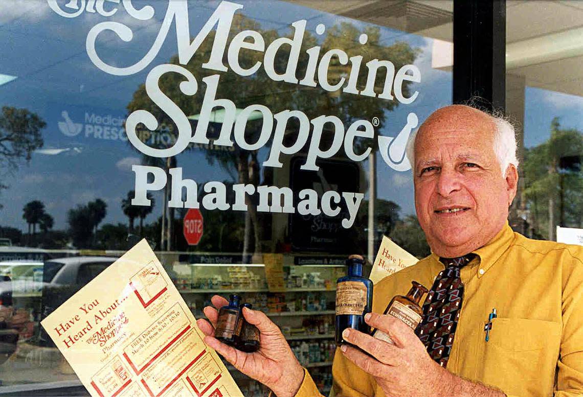 Outside Cooper City’s Medicine Shoppe in 1999, owner-pharmacist Philip Schutzer shows off a few of the antique medicine bottles he collects.