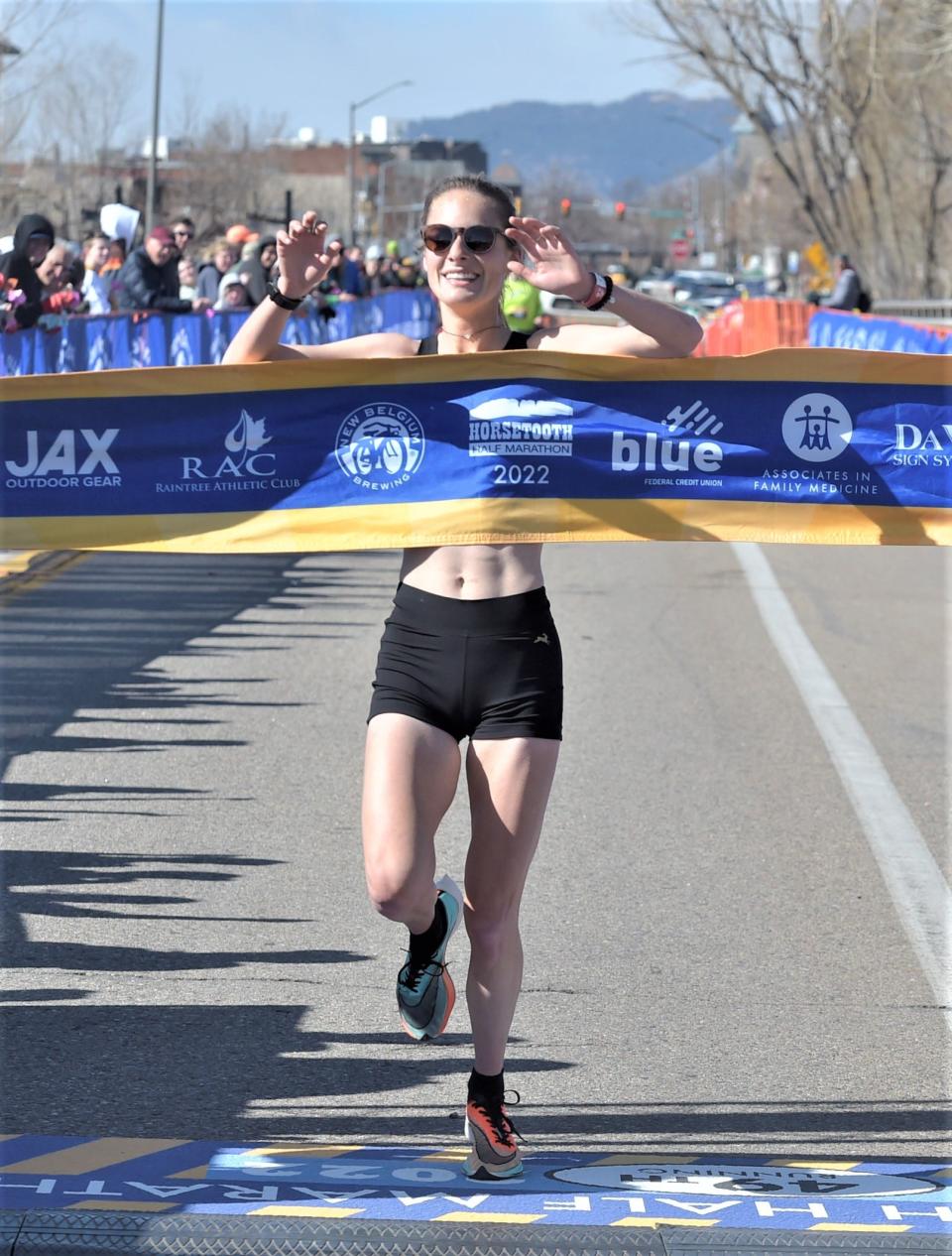 Elizabeth Lagoy of Salt Lake City, Utah, breaks the tape at the finish line as the women's winner of the Horsetooth Half Marathon on Sunday in Fort Collins.