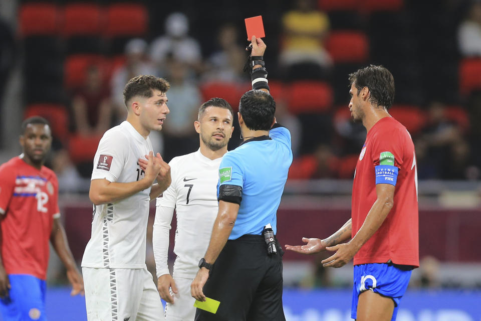 New Zealands's Kosta Barbarouses, center, gets red card during the World Cup 2022 qualifying play-off soccer match between New Zealand and Costa Rica in Al Rayyan, Qatar, Tuesday, June 14, 2022. (AP Photo/Hussein Sayed)