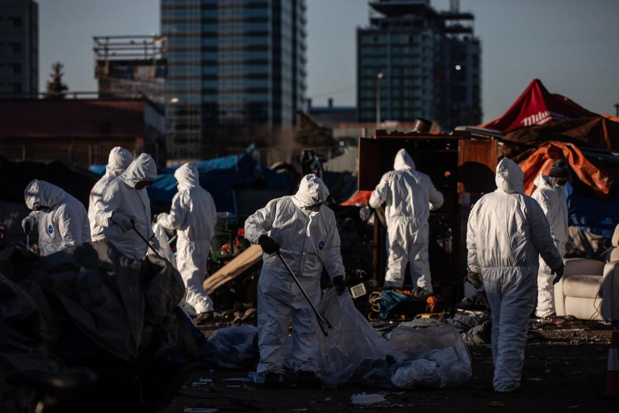 Cleanup crews tear down homeless encampments in Edmonton on Friday, Dec. 29, 2023. (Jason Franson/The Canadian Press - image credit)