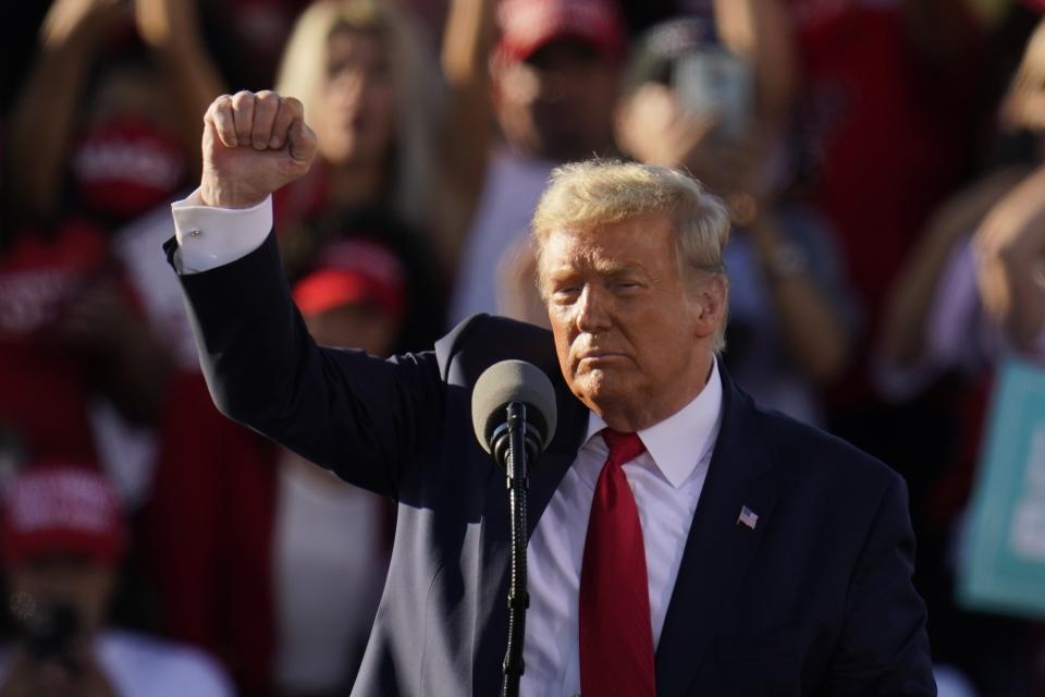 President Donald Trump pumps his fist after speaking at a campaign rally at Phoenix Goodyear Airport Wednesday, Oct. 28, 2020, in Goodyear, Ariz. (AP Photo/Ross D. Franklin)