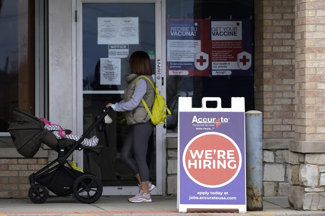 **HOLD For BIZ** A hiring sign is seen outside of Accurate Personnel office (employment agency) in Buffalo Grove, Ill., Friday, Dec. 3, 2021. A week after Thanksgiving, Illinois on Thursday reported this year's highest daily total of new coronavirus cases, while COVID-19 hospitalizations have risen higher than any point since last winter. (AP Photo/Nam Y. Huh)