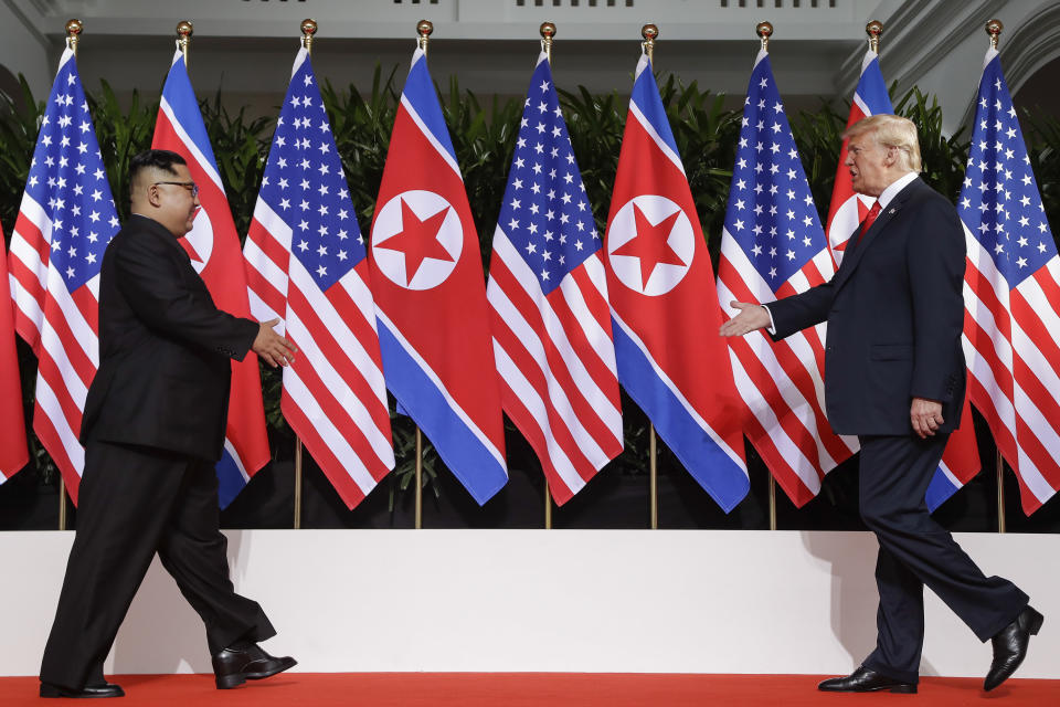 FILE - This June 12, 2018, file photo, U. S. President Donald Trump and North Korea leader Kim Jong Un walks toward each other at the Capella resort on Sentosa Island in Singapore. Trump and Kim will likely be all smiles as they shake hands later this week in Hanoi for a meeting meant to put flesh on what many critics call their frustratingly vague first summit in Singapore. But behind the grins is a swirl of competing goals and fears. (AP Photo/Evan Vucci, File)