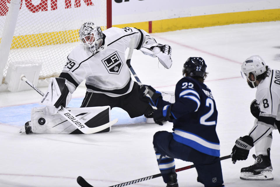 Los Angeles Kings goaltender Cam Talbot makes a save on Winnipeg Jets center Mason Appleton (22) during the first period of an NHL hockey game, Tuesday, Oct. 17, 2023 in Winnipeg, Manitoba. (Fred Greenslade/The Canadian Press via AP)