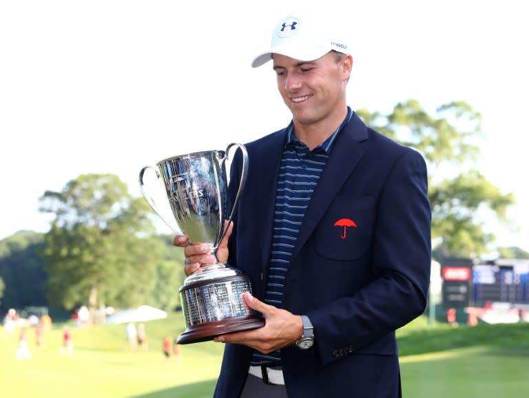 Jordan Spieth of the US poses with the winner's trophy after defeating Daniel Berger in a playoff in the final round of the Travelers Championship, at TPC River Highlands in Cromwell, Connecticut, on June 25, 2017