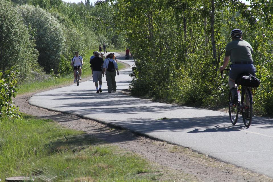 This photo taken June 11, 2013, shows people using the Tony Knowles Coastal Trail in downtown, Anchorage, Alaska. Anchorage offers more than 135 miles of multi-use trails in the city. (AP Photo/Mark Thiessen)