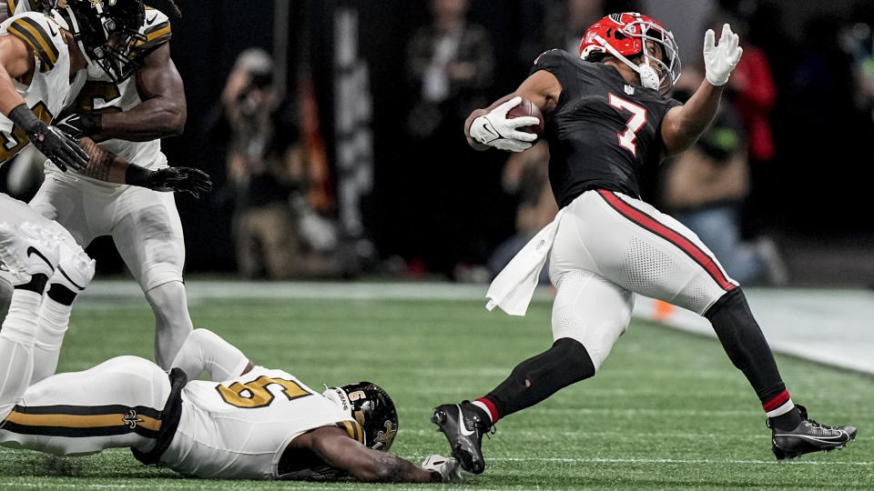 New Orleans Saints safety Marcus Maye (6) trips up Atlanta Falcons running back Bijan Robinson (7) during the first half of an NFL football game, Sunday, Nov. 26, 2023, in Atlanta. (AP Photo/Brynn Anderson)