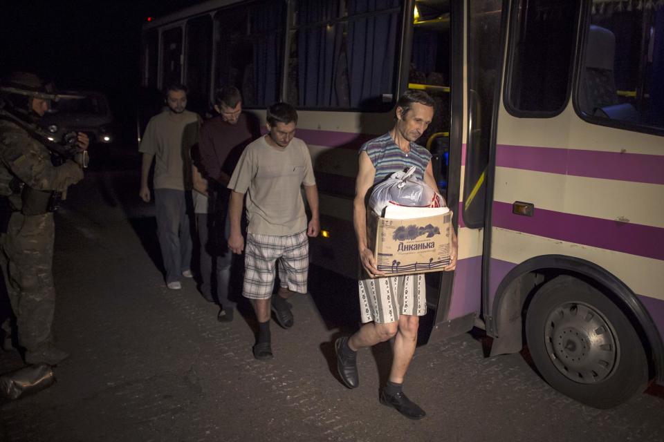 Members of the pro-Russian rebels, who are prisoners-of-war, walk along a road as they are being exchanged, north of Donetsk, eastern Ukraine