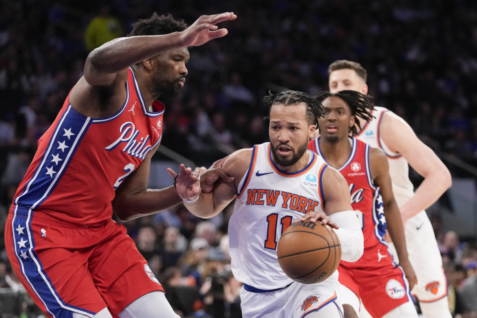 New York Knicks guard Jalen Brunson (11) drives against Philadelphia 76ers center Joel Embiid, left, during the second half in Game 1 of an NBA basketball first-round playoff series, Saturday, April 20, 2024, at Madison Square Garden in New York. (AP Photo/Mary Altaffer)