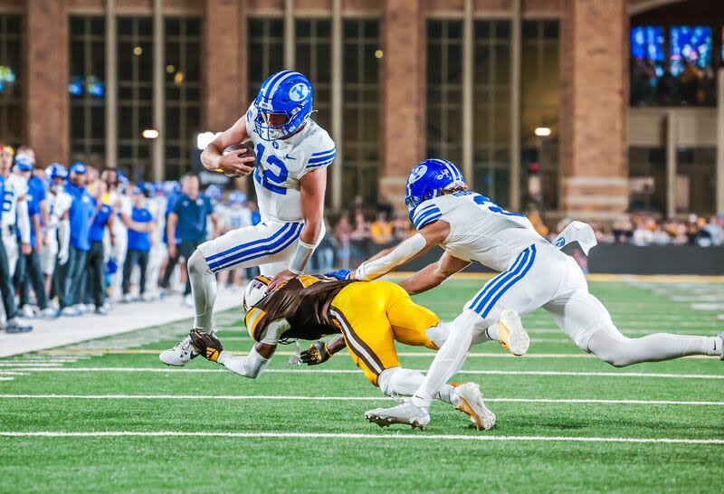 BYU quarterback Jake Retzlaff escapes a Wyoming defender on Saturday, Sept. 14 in Laramie, Wyo. | BYU Photo