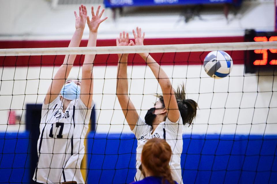 Whitesboro's Eva Quackenbush (17) and a teammate attempt to block a kill during the volleyball game against New Hartford on Wednesday night. New Hartford won 3-1.