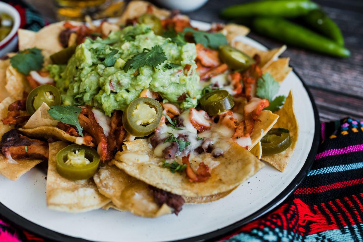 Mexican nachos chips with american cheese and avocado, traditional food in Mexico Latin America