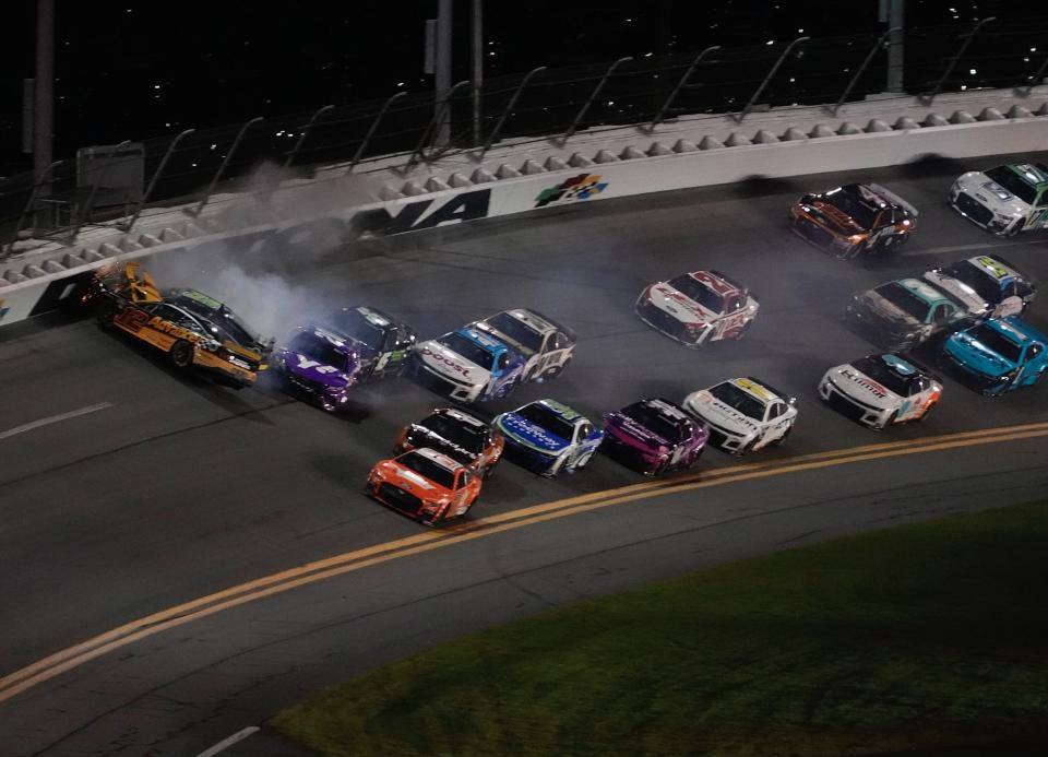 Ryan Blaney (12) is turned nose-first into the wall after contact from Ty Gibbs (54), setting off a massive collision at the end of Stage 2 on Saturday in the Coke Zero Sugar 400 at Daytona.