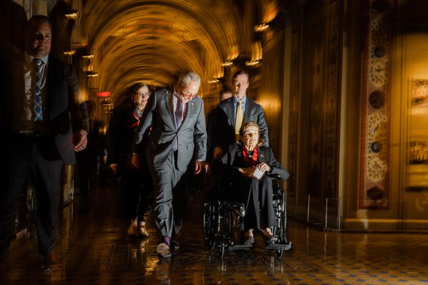 WASHINGTON, DC - MAY 10: Sen. Dianne Feinstein (D-CA) is escorted by Senate Majority Leader Chuck Schumer (D-NY), into the Senate side of the the U.S. Capitol on Wednesday, May 10, 2023 in Washington, DC. Feinstein's return to Congress, bookends a more than two-month absence from the nation's capitol due to illness. (Kent Nishimura / Los Angeles Times)