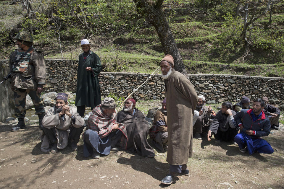 Elderly Kashmiri voters wait to cast their votes, outside a polling station during the second phase of India's general elections in Baba Nagri, about 44 kilometers (28 miles) northeast of Srinagar, Indian controlled Kashmir, Thursday, April 18, 2019. Kashmiri separatist leaders who challenge India's sovereignty over the disputed region have called for a boycott of the vote. Most polling stations in Srinagar and Budgam areas of Kashmir looked deserted in the morning with more armed police, paramilitary soldiers and election staff present than voters. (AP Photo/ Dar Yasin)