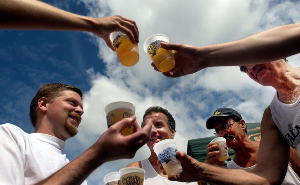 From left, Ron Johnson, Dick Doran, Tom Scott, Wes Chadbourne and two more of their fellow Massachusetts compatriots toast their post race Saranac beers to the 26th Annual 15k Utica Boilermaker Road Race at the post race party in July, 2003.
