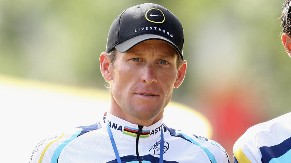 Cyclist Lance Armstrong during the Tour de France stares forward on the podium.