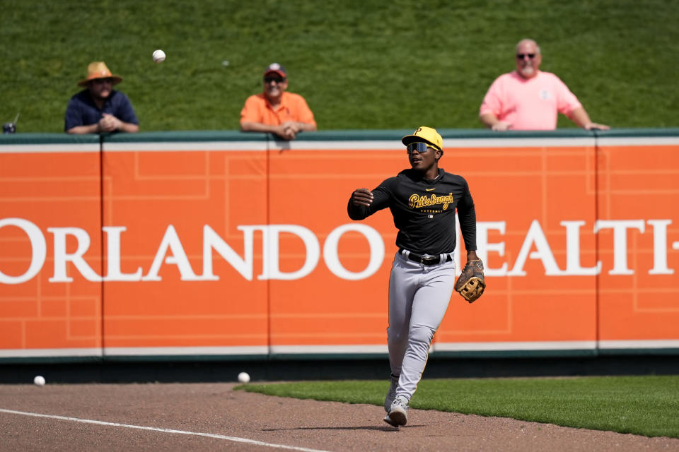 Pittsburgh Pirates second baseman Termarr Johnson tosses a baseball to a fan before a spring training baseball game against the Detroit Tigers Saturday, March 9, 2024, in Lakeland, Fla. (AP Photo/Charlie Neibergall)