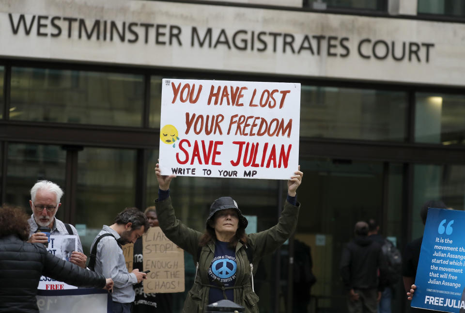 Supporters of WikiLeaks founder Julian Assange protest in front of Westminster Magistrates' Court in London, Monday, June 29, 2020, where he is expected to appear in custody for the extradition case management hearing. Assange was arrested last year after being evicted from the Ecuadorian Embassy in London, where he had sought refuge to avoid being sent to Sweden over allegations of rape and sexual assault, and is at the center of an extradition tussle over whether he should be sent to the United States. (AP Photo/Frank Augstein)