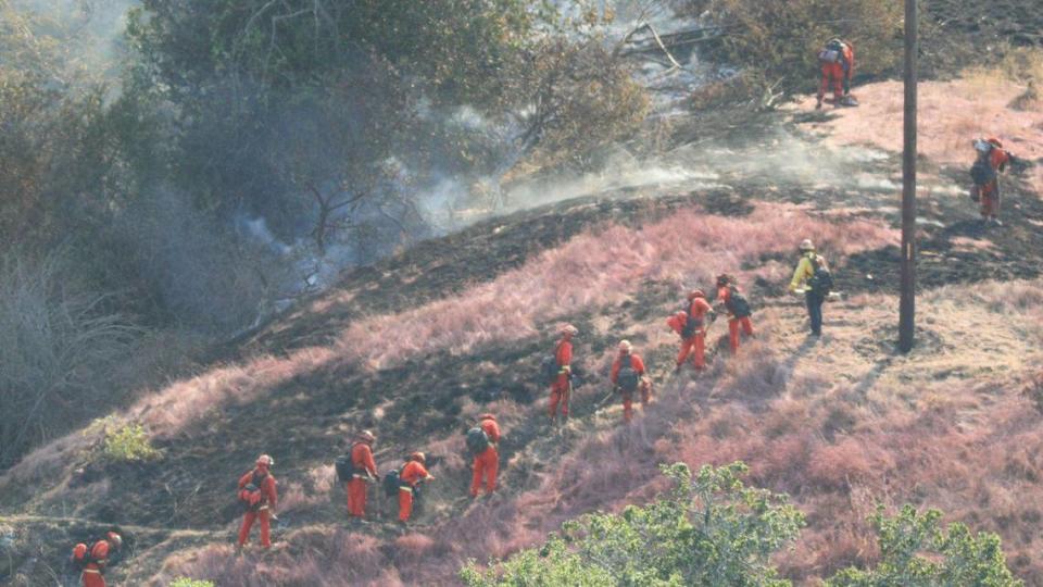 Inmate fire crew works on cutting fire line as crews battled the Green Fire south of Highway 46 West on Oct. 6, 2023.