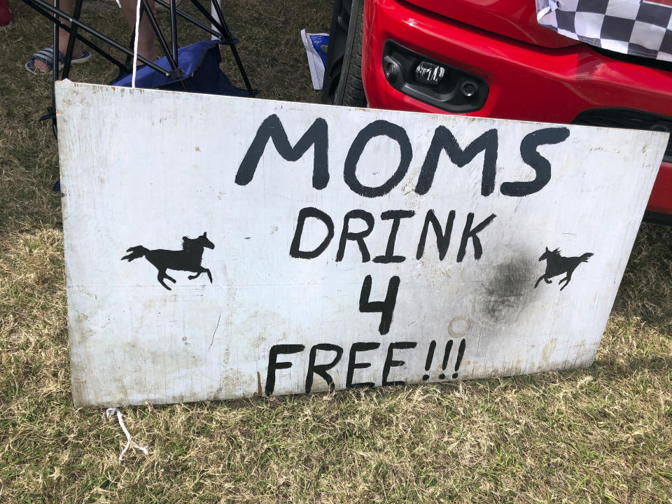 A sign is shown in the infield at the Daytona International Speedway before a truck race Friday, Feb. 12, 2021, in Daytona Beach, Fla. Daytona is used to shirtless fans partying in the infield. But what about maskless ones? Usually the biggest NASCAR party of the season, the sport will have to figure out how to police up to 30,000 fans who may have little interest in sticking to the pandemic guidelines. How many fans will actually come remains to be seen.(AP Photo/Daniel Gelston)