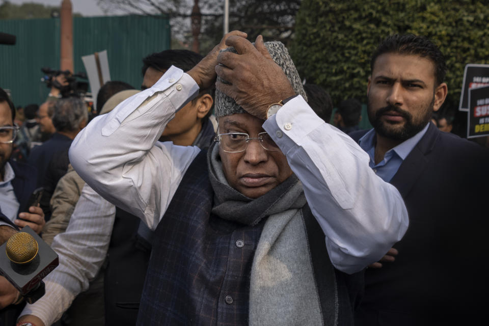 Congress party President Mallikarjun Kharge adjusts his cap as suspended lawmakers marched briefly outside the Parliament House in New Delhi, India, Thursday, Dec. 21, 2023. Dozens of opposition lawmakers suspended from Parliament by Prime Minister Narendra Modi's government for obstructing proceedings in the chamber held a street protest on Thursday accusing the government of throttling democracy in the country. (AP Photo/Altaf Qadri)