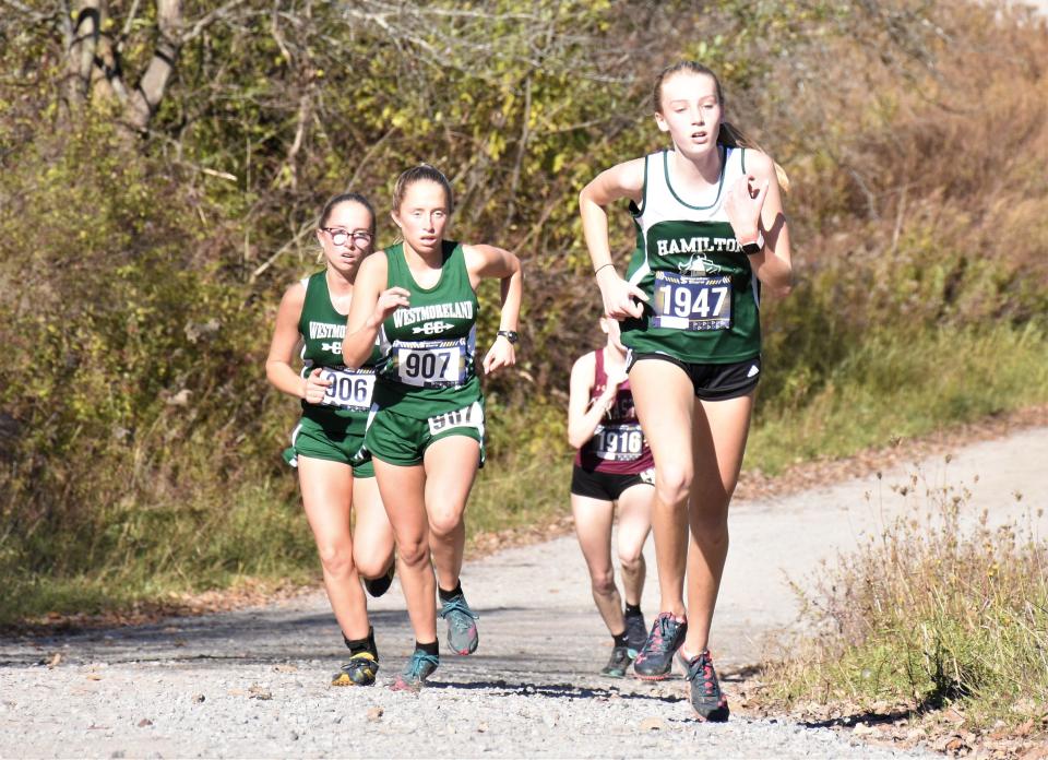 Hamilton Emerald Knight Claire Filipowicz (1947) reaches the the top of the final hill on the Herkimer College course ahead of Westmoreland Bulldogs Tessie Shafer (906) and Marlee Shafer (907) at the Center State Conference championship cross country meet Saturday.