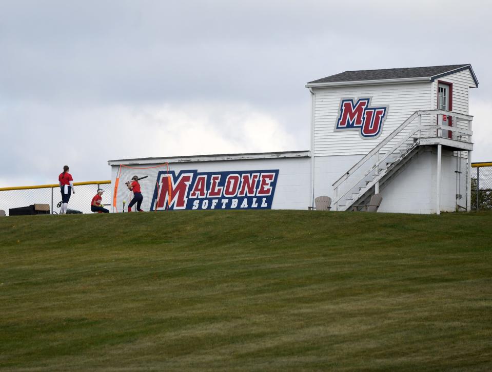 The Malone University Softball Team warms up for the start of a fall game at Malone University in Canton. Wednesday, Oct. 4, 2024