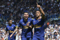Newcastle's Callum Wilson, right, celebrates with teammate Jacob Murphy after scoring his side's 2nd goal from the penalty spot during the English Premier League soccer match between Leeds United and Newcastle United at Elland Road in Leeds, England, Saturday, May 13, 2023. (AP Photo/Rui Vieira)