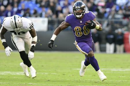 FILE PHOTO: Nov 25, 2018; Baltimore, MD, USA; Baltimore Ravens running back Ty Montgomery (88) rushes by Oakland Raiders defensive end Fadol Brown (95) during the fourth quarter at M&T Bank Stadium. Mandatory Credit: Tommy Gilligan-USA TODAY Sports