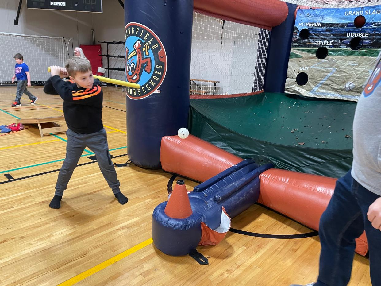 Corbin Harrison, 10, takes a crack at hitting a wiffleball at  the Springfield Lucky Horseshoes station at the Downtown Kiwanis Kidsbash Saturday, Jan. 28, 2023 at the Salvation Army.