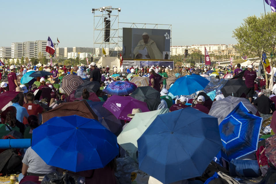 Pilgrims gather at Parque Tejo in Lisbon where Pope Francis is presiding over a mass celebrating the 37th World Youth Day, Sunday, Aug. 6, 2023. An estimated 1.5 million young people filled the parque on Saturday for Pope Francis' World Youth Day vigil, braving scorching heat to secure a spot for the evening prayer and to camp out overnight for his final farewell Mass on Sunday morning. (AP Photo/Ana Brigida)