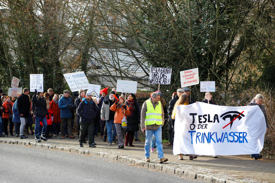 Demonstrators hold anti-Tesla posters during a protest against plans by U.S. electric vehicle pioneer Tesla to build its first European factory and design center in Gruenheide near Berlin, Germany January 18, 2020. REUTERS/Pawel Kopczynski