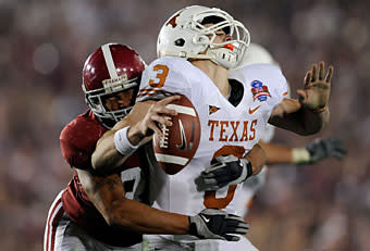 Texas QB Garrett Gilbert fumbles the ball as he is hit by Alabama linebacker Eryk Anders in the fourth quarter